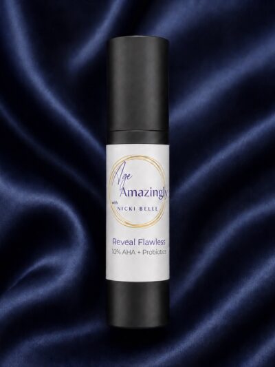 Age Amazingly with Nicki Belle Reveal Flawless 10% AHA and Probiotics in a black airless pump bottle.